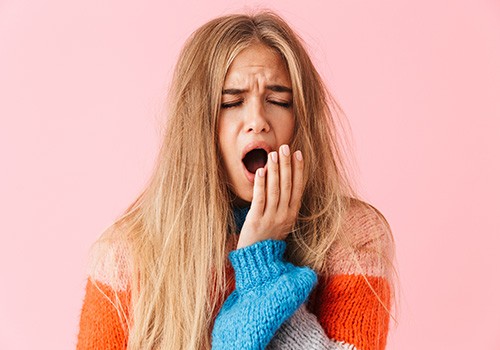 a closeup of a woman yawning