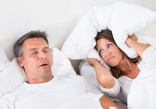 a man snoring and disturbing his partner