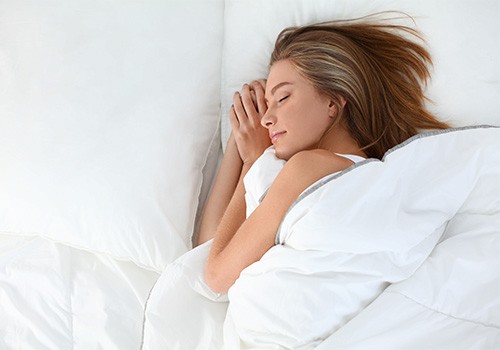 Woman sleeping peacefully in bed