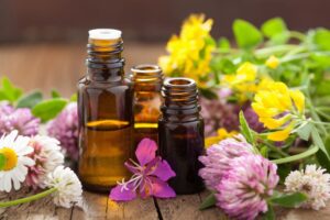 Essential oils surrounded by colorful flowers